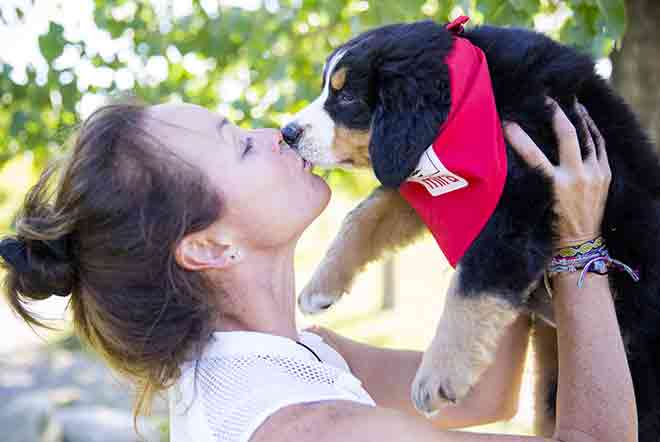 Une jeune femme d’une famille d’accueil embrasse son chien Mira